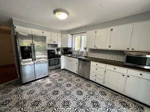 Fridge, microwave, oven, stovetop - Marvelous 4-bedroom, 2-bath home with AC and private backyard close to the beach (Narragansett)
