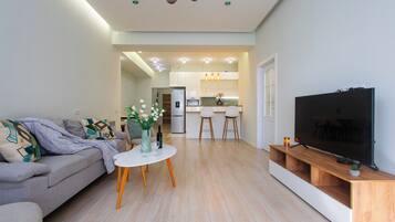 Family Apartment | Living area | 50-inch flat-screen TV with cable channels