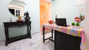 A room with a desk, a mirror, a laptop, and decorative items. - Nautical Escape Homestay - Pondicherry (Puducherry)
