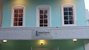 A two-story building with a sign reading "NAUTICAL E-SOAPE" on the facade. - Nautical Escape Homestay - Pondicherry (Puducherry)