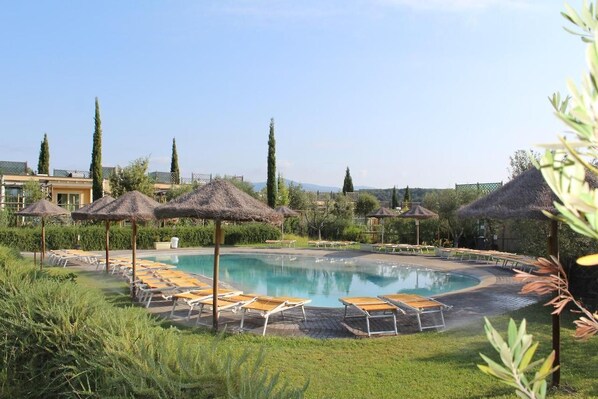 Seasonal outdoor pool, open 9:00 AM to 7:00 PM, pool umbrellas