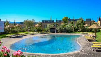 Seasonal outdoor pool, open 9:00 AM to 7:00 PM, pool umbrellas