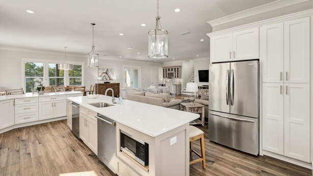 A spacious kitchen with white cabinetry, a large island, stainless steel appliances, and pendant lighting. - Rising Tide | Private Pool/Spa | 6-Seater Golf Cart | Private Beach Access (Miramar Beach)
