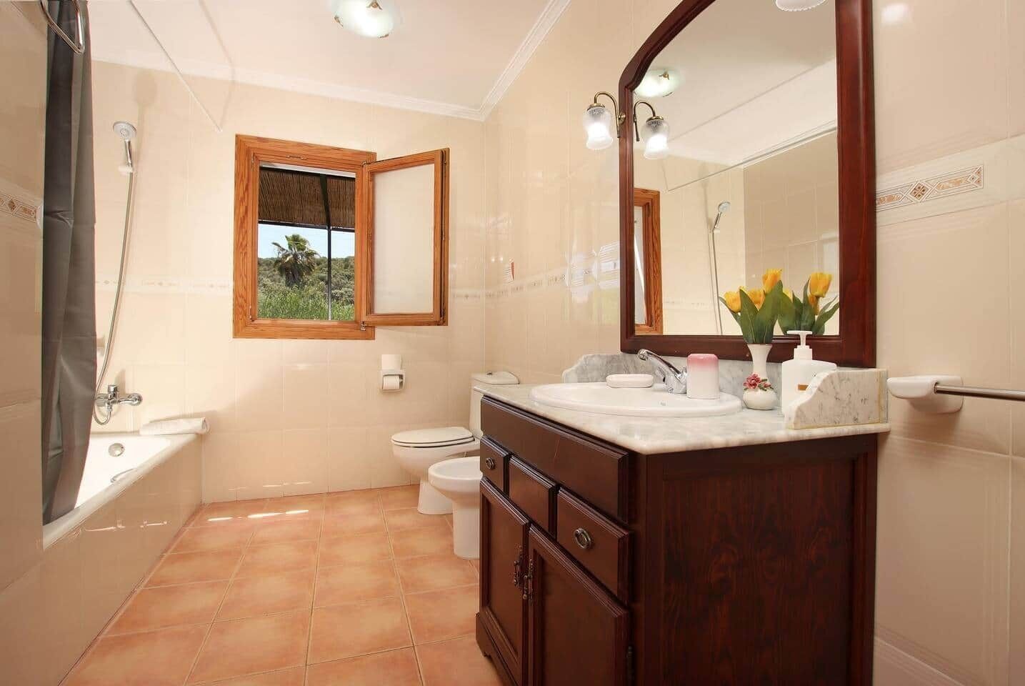 A bathroom with a bathtub, toilet, and sink.