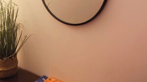 A round mirror with a decorative metal frame on a wall. - Anna Cerasuolo House | Whole house in mountain hamlet (Molise)