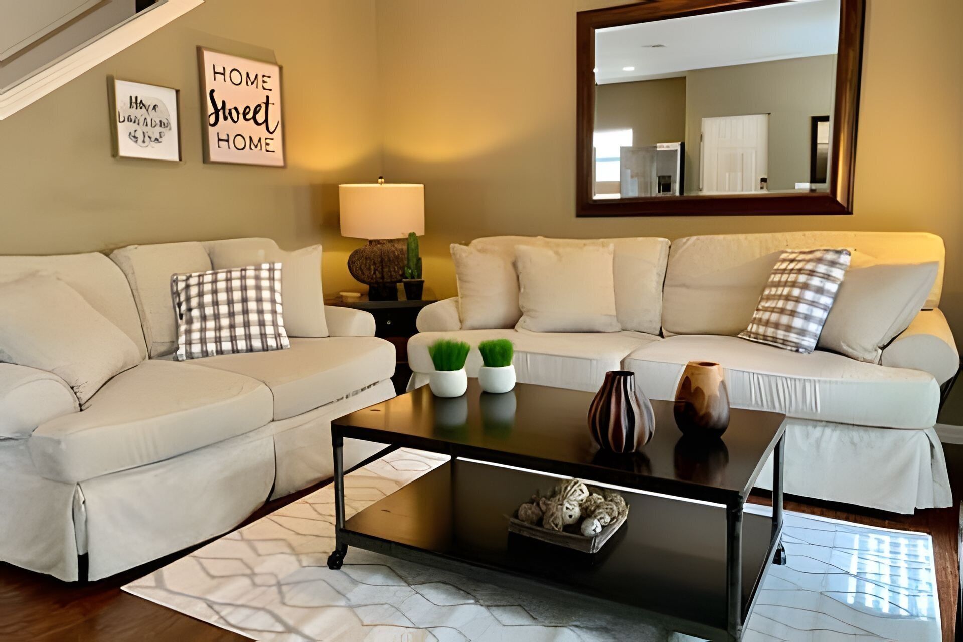 A living room with a sofa set, a coffee table, and decorative items.