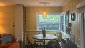 A cozy dining area with a round table, chairs, and a hanging light fixture. - Peaceful 2-bedroom house in charming Trussville (Trussville)