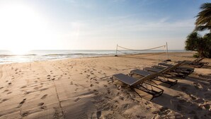 A beach with footprints, a volleyball net, and sun loungers. - Ace of Hua Hin Resort - Ace Junior Suite Pool Access (Cha-am)