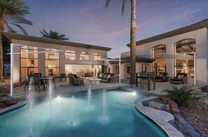 A modern building with a pool, outdoor seating, and a cafe named "Putters Cafe". - Pure Suites Scottsdale Kierland Commons Scottsdale Quarter 2 Bed Pool Gym (Scottsdale)