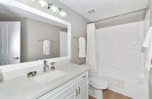 A modern bathroom with a large mirror, two sinks, a toilet, and a shower. - Pure Suites Scottsdale Kierland Commons Scottsdale Quarter 2 Bed Pool Gym (Scottsdale)