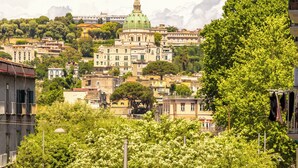 A cityscape with a prominent green-roofed building in the background, surrounded by lush greenery and residential buildings. - Guest Rooms Bellini - Totò - Studios Superior (Naples)
