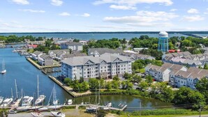 A marina with boats, a water tower, and residential buildings. - Welcome to a Cozy Waterfront Condo in Charming Cambridge, MD (Cambridge)