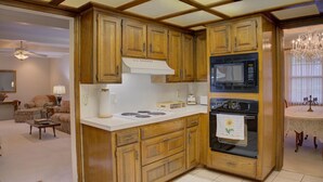 A compact kitchen with wooden cabinets, a microwave, an oven, and a gas stove. - Nice 4-bedroom house with large rooms in Broken Arrow (Broken Arrow)