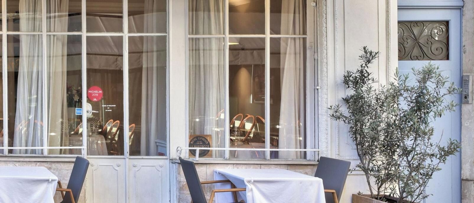 A restaurant named 'Restaurant Kigali' with outdoor seating and a view of the street.