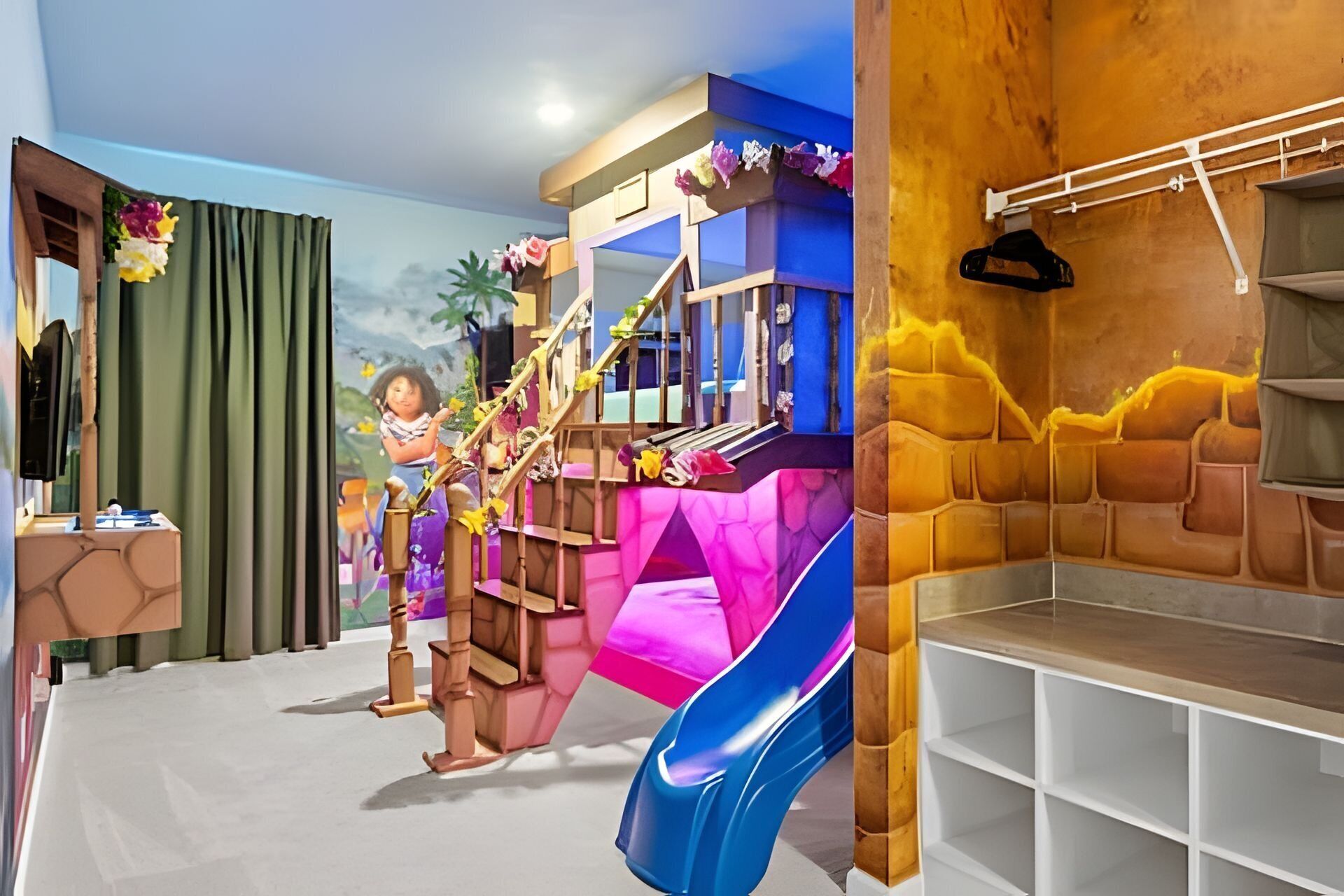 A children's play area with a slide, climbing structures, and a small seating area.