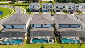 A residential area with multiple houses, each featuring a swimming pool. - Luxury 6BR Near Universal, Pool, Spa & Game Room (Orlando)