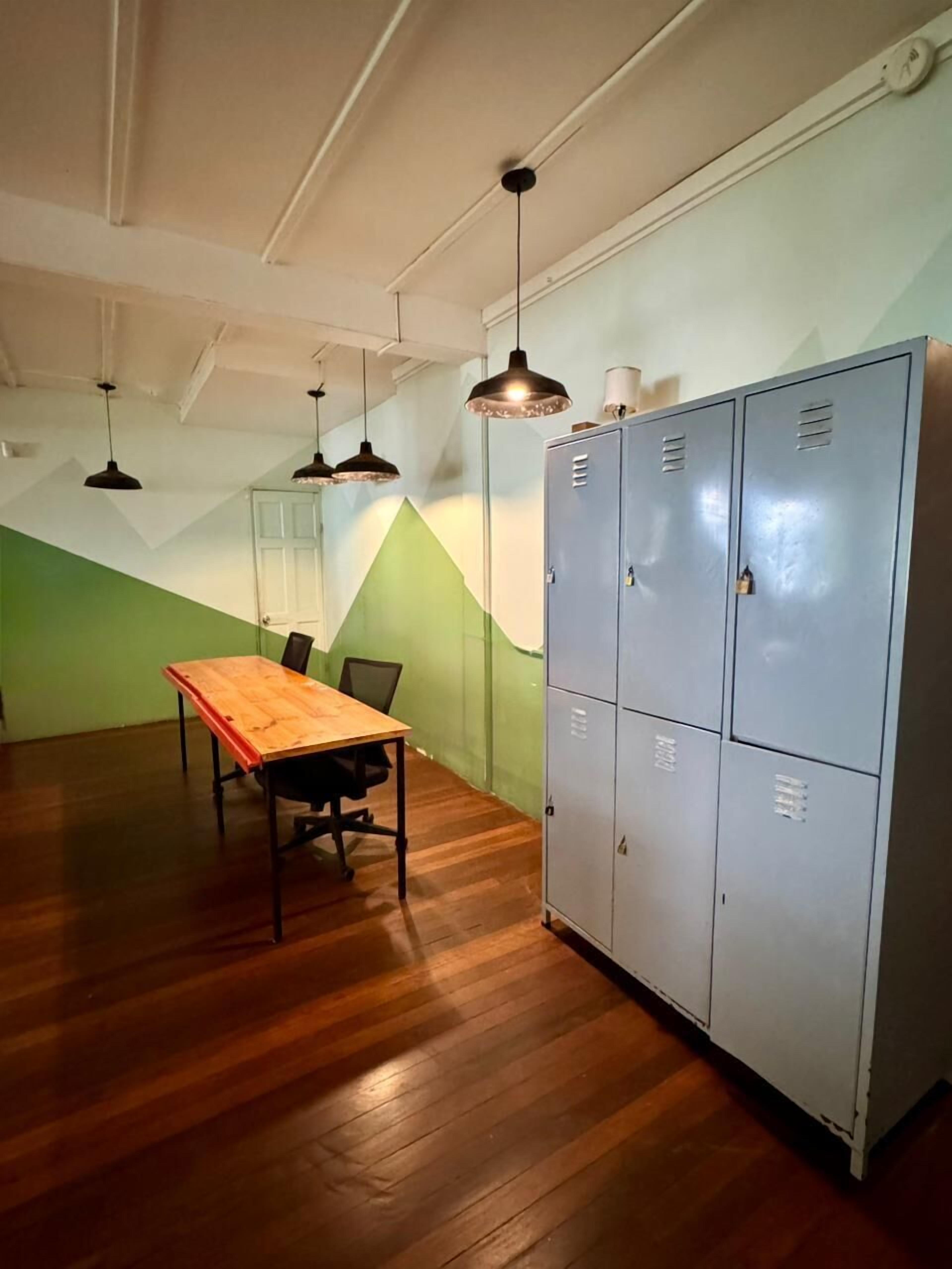 A conference room with a wooden table, chairs, and a large metal filing cabinet.