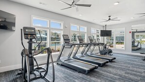 A gym with treadmills, an elliptical, and a stationary bike. - Landing | Stunning 1BD, Gym, Yoga Studio (Myrtle Beach)