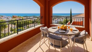A balcony with a table set for two, overlooking a coastal view. - -Nuevo Anuncio- Bádminton Villa & Sea Views (Finestrat)