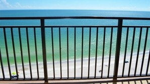 A balcony with a view of the ocean and beach. - Beachfront condo at Mansions (TREASURE ISLAND)