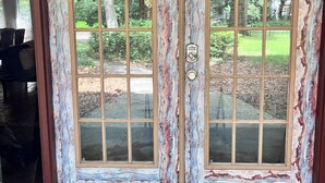 A set of double wooden doors with a unique marbled finish and a keypad lock. - Refuge Home, Jacuzzi & Heated Pool 35 min Orlando. (Eustis)