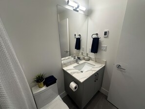 Een haardroger, handdoeken, zeep, toiletpapier