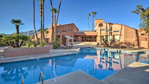 A pool area with lounge chairs, palm trees, and a building with a mountain backdrop. - 3 Mi to Sabino Canyon: Condo w/ Resort Perks! (Tucson)