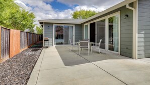 A modern house with a patio, sliding glass doors, and a wooden fence. - Quiet & Convenient! Santa Rosa Family Home w/ Yard (Santa Rosa)