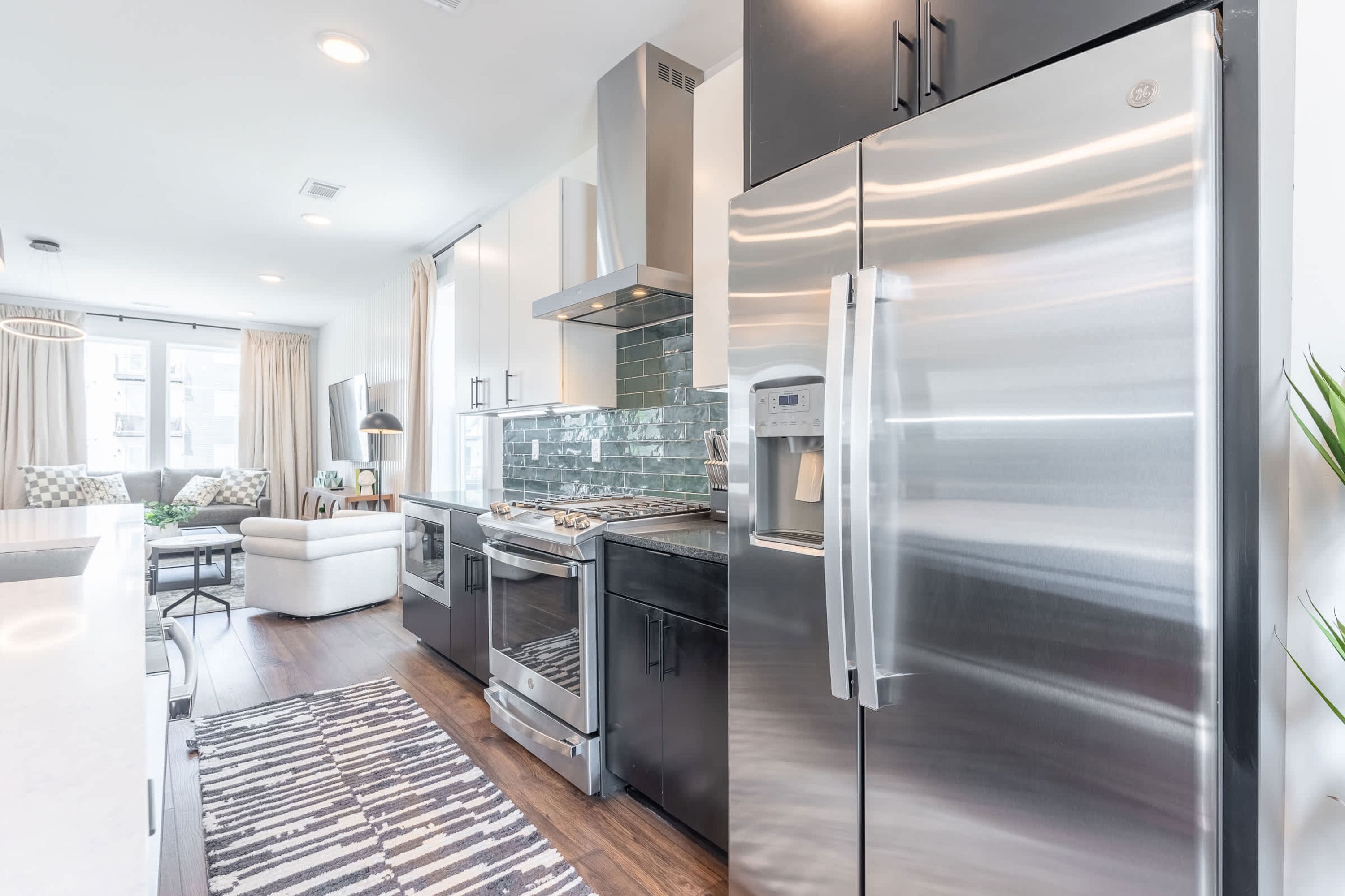 A modern kitchen with stainless steel appliances, a built-in oven, and a large refrigerator.