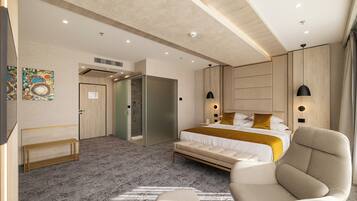 Una habitación de hotel moderna con una cama grande, un sofá, un banco y un vestidor.