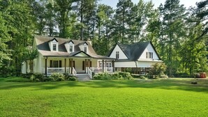 A two-story house with a front porch and a covered porch area.