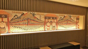 A wall with a large, illuminated artwork depicting a traditional scene. - Stay Sakura Tokyo Asakusa Yokozuna Hotel (Tokyo)