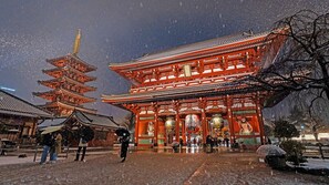 A traditional Japanese building with a multi-tiered pagoda and a main hall.
