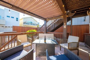 An outdoor patio with a table set for dining, wicker furniture, and a pergola overhead. - Steps to Beach: Fire Pit, Surfing & Dunes Access. Perfect for two couples! (Oceano)