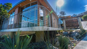 A modern building with large windows and a wooden facade. - anchor inn pacifica (Pacifica)
