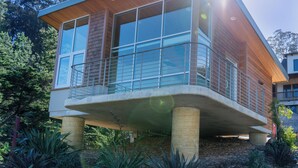 A modern house with a balcony, large windows, and a wooden exterior. - anchor inn pacifica (Pacifica)