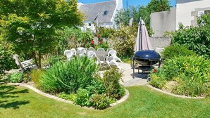 A well-maintained garden with a barbecue area, outdoor seating, and lush greenery. - 5 bedroom lovely home in Saint-Martin-des-Champ (Saint-Martin-des-Champ)