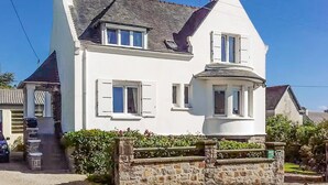 A two-story house with a stone facade, a pitched roof, and a small porch. - 5 bedroom lovely home in Saint-Martin-des-Champ (Saint-Martin-des-Champ)