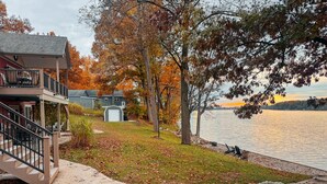A residential property with a two-story house, a covered porch, and a view of a lake. - Lakefront - Sleeps 16 - Two Kitchens - Play Room (Union City)