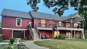 A two-story red house with a front porch, a staircase, and a covered balcony. - Lakefront - Sleeps 16 - Two Kitchens - Play Room (Union City)