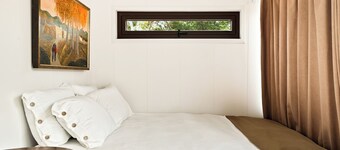 LUXX Space Cabin Tiny House with rooftop deck, private fenced patio.