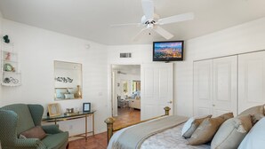 A bedroom with a bed, a chair, a TV, and a desk. - Spacious and quiet 2-bedroom casita with view in Fountain Hills (Fountain Hills)
