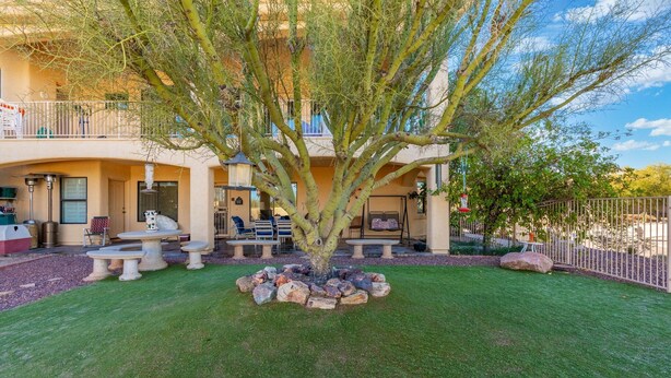 A two-story building with a patio area featuring outdoor seating and a tree. - Spacious and quiet 2-bedroom casita with view in Fountain Hills (Fountain Hills)