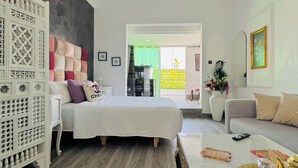 A modern bedroom with a bed, a white dresser, a sofa, and a coffee table. - Studio downtown Rabat terrace (Rabat)