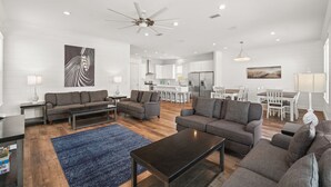 A modern living room with a sofa set, a coffee table, and a blue rug. - Ellis Retreat with LSV, Arcade, and Billiards (Miramar Beach)