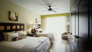 A hotel room with two beds, a ceiling fan, a nightstand with a lamp, a chair, and a wardrobe. -  Available Dec 20-27th Christmas in the Sun 2bdrm 3 bath Luxury Condo In Cancun! (Cancún)