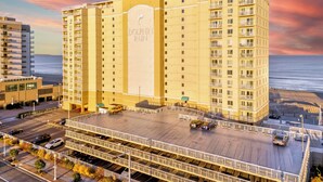A high-rise hotel with multiple balconies and a view of the beach. - Oceanfront 3BR Dolphin Run condo with balcony and pool. (Virginia Beach)