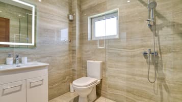 Designer toiletries, hair dryer, slippers, towels