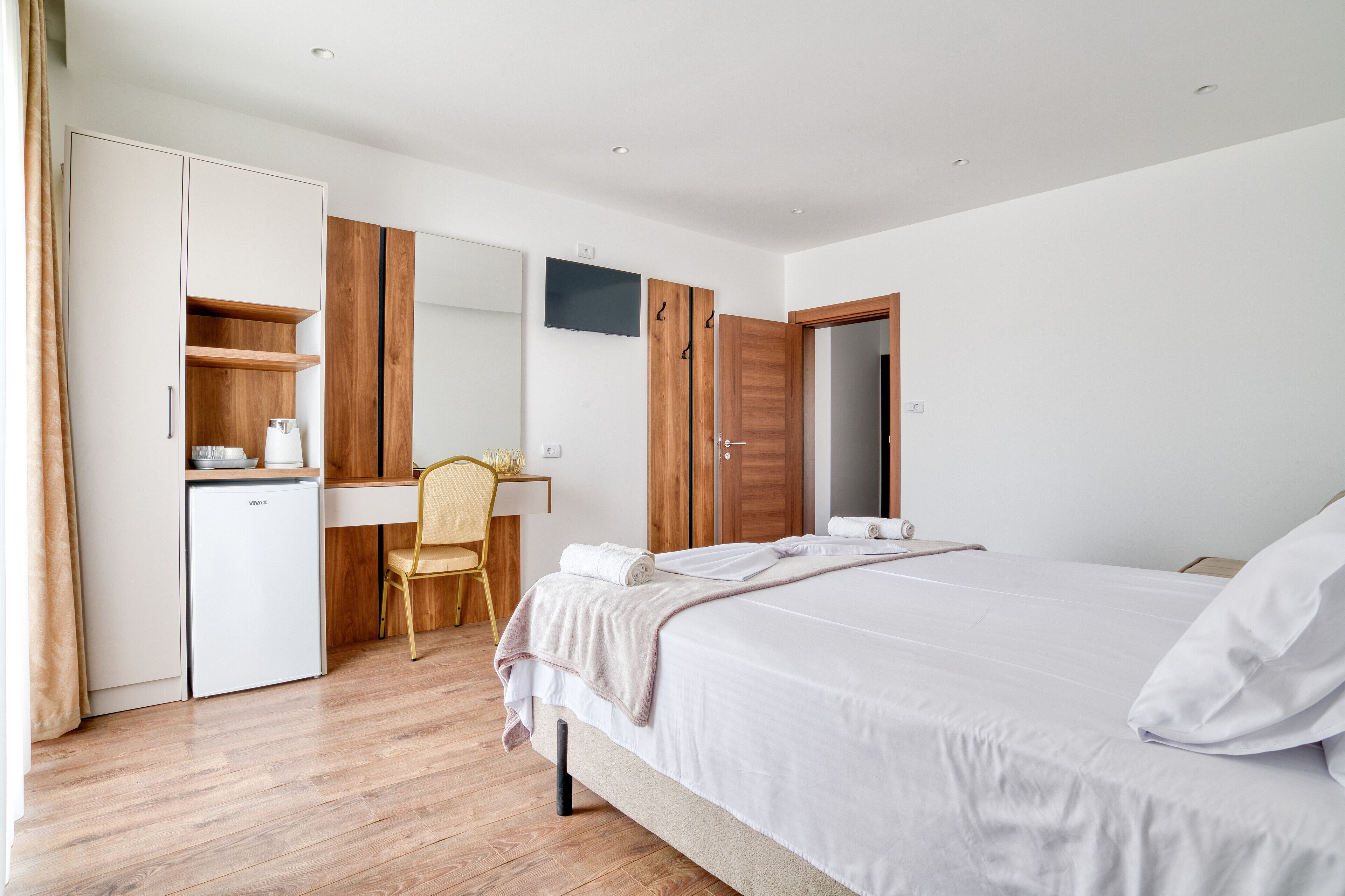 Une chambre à coucher comprenant un lit, un bureau, une chaise et une armoire.