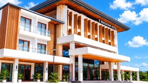 A modern hotel with a two-story structure, large glass windows, and a prominent sign reading 'B MADAYAW HOTEL'.